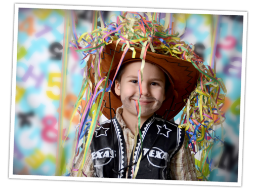 Ein Geburtstagskind, als Cowboy verkleidet, mit Luftschlangen oben auf dem Hut freut sich auf freien Eintritt ins FORT FUN.